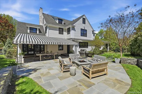 a view of a house with backyard and sitting area