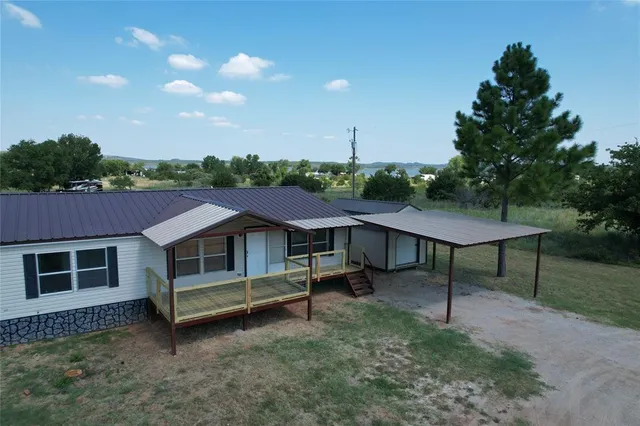 a aerial view of a house with a yard and sitting area