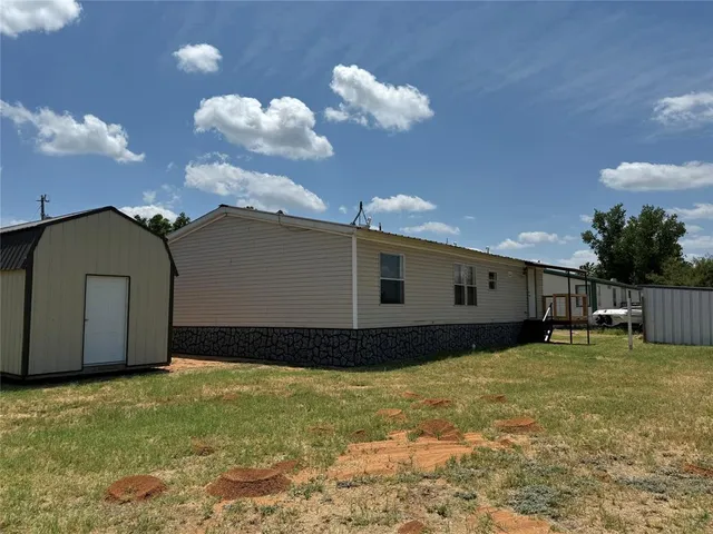 a view of a backyard of the house