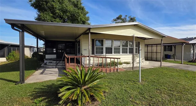a view of a house with backyard and porch