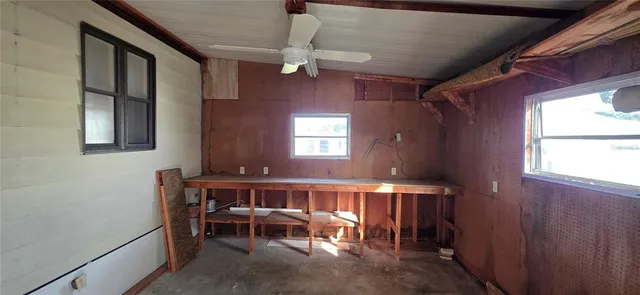 a view of a park with large trees and a barn in it