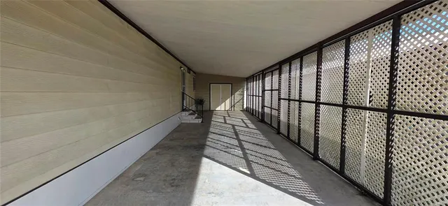 a view of a house with a big yard and a large trees