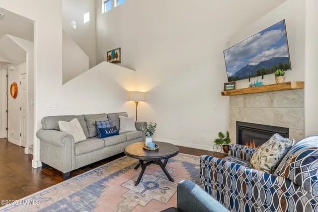 a kitchen with stainless steel appliances granite countertop a stove a sink dishwasher and refrigerator with wooden floor