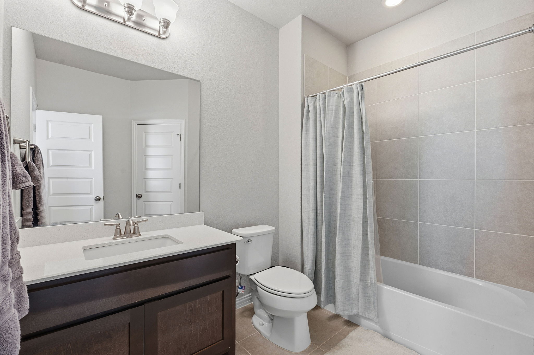 12616 Twisted Root Drive Manchaca, TX 78652 - Photo 24 of 36 One of two secondary bathrooms, this shared bath offers a shower/tub combo and single vanity.