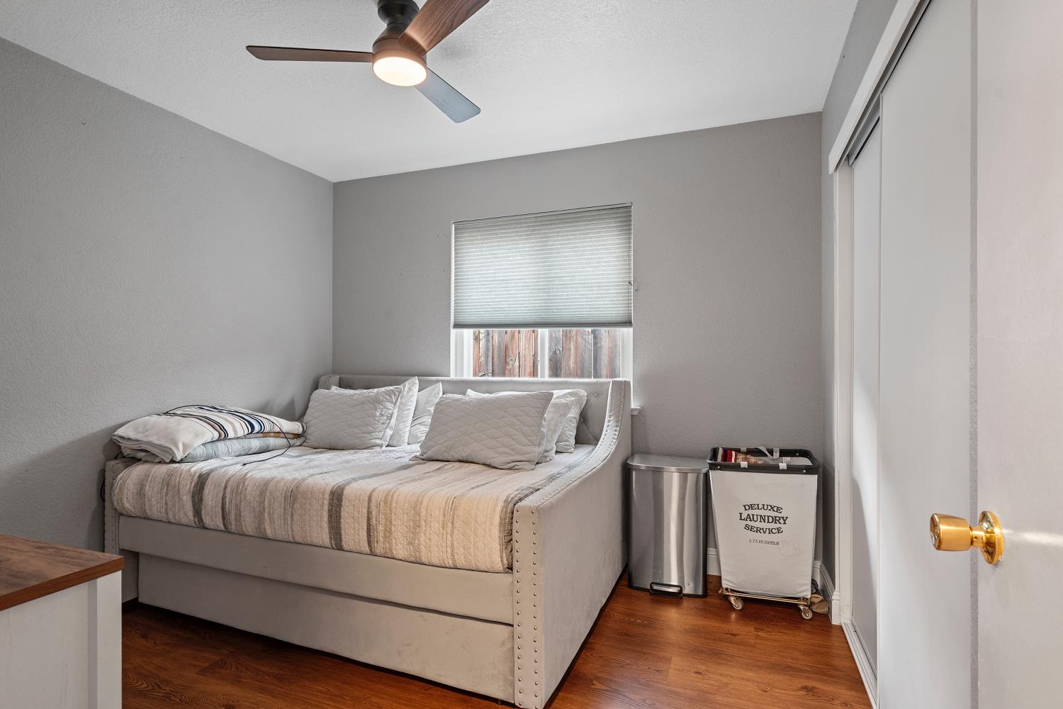 7013 Tiant Way Elk Grove, CA 95758 - Photo 11 of 17 a living room with a bed and a lamp on the dresser