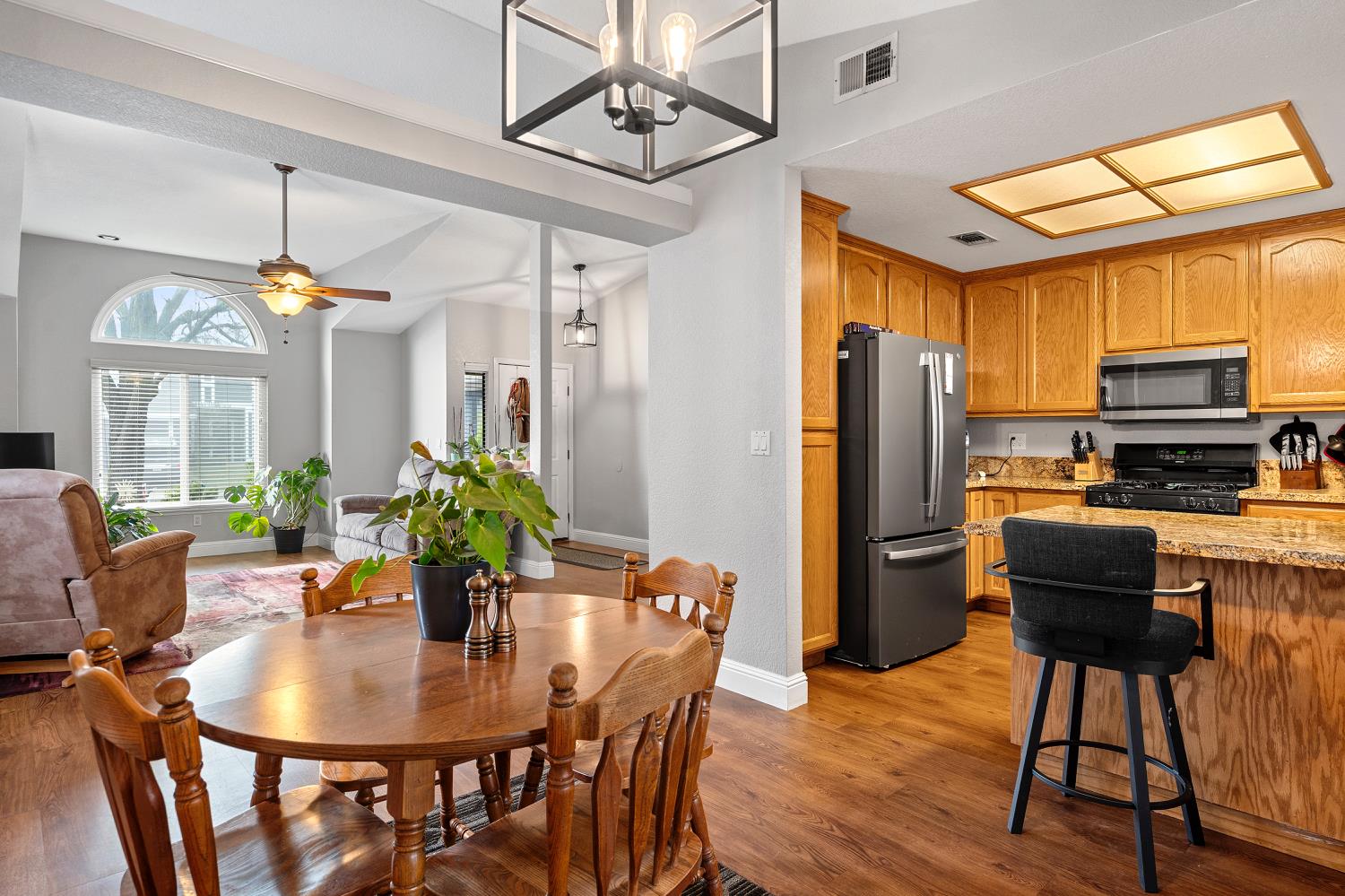 7013 Tiant Way Elk Grove, CA 95758 - Photo 5 of 17 a dining room with furniture a chandelier and wooden floor