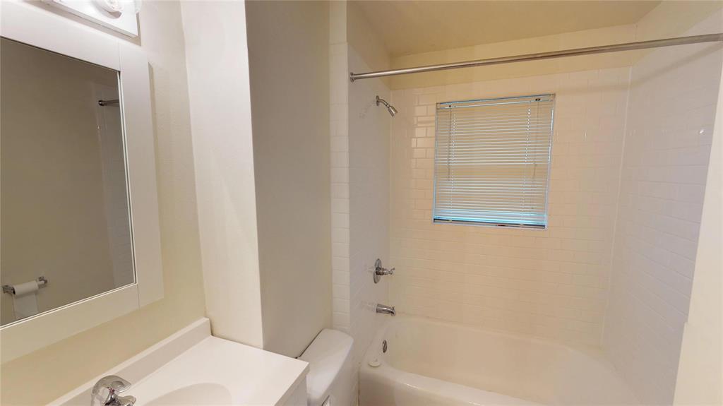 1705 Crescent Street Denton, TX 76201 - Photo 5 of 7 a bathroom with a bathtub and a shower