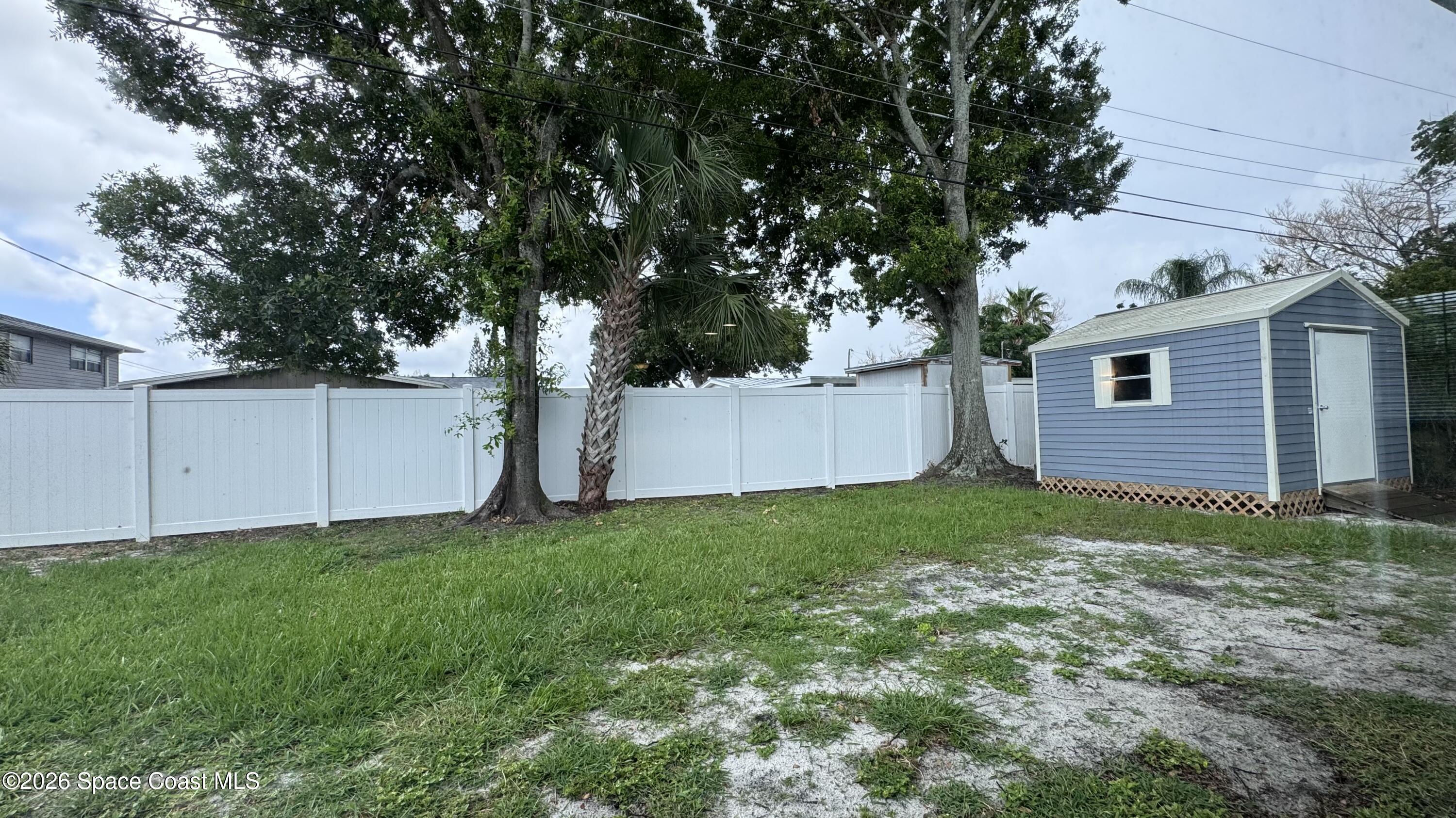 2137 Laden Road Melbourne, FL 32935 - Photo 23 of 23 a view of a backyard with plants and large trees