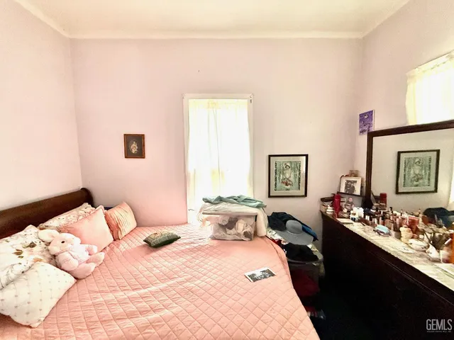 a bedroom with a bed and window