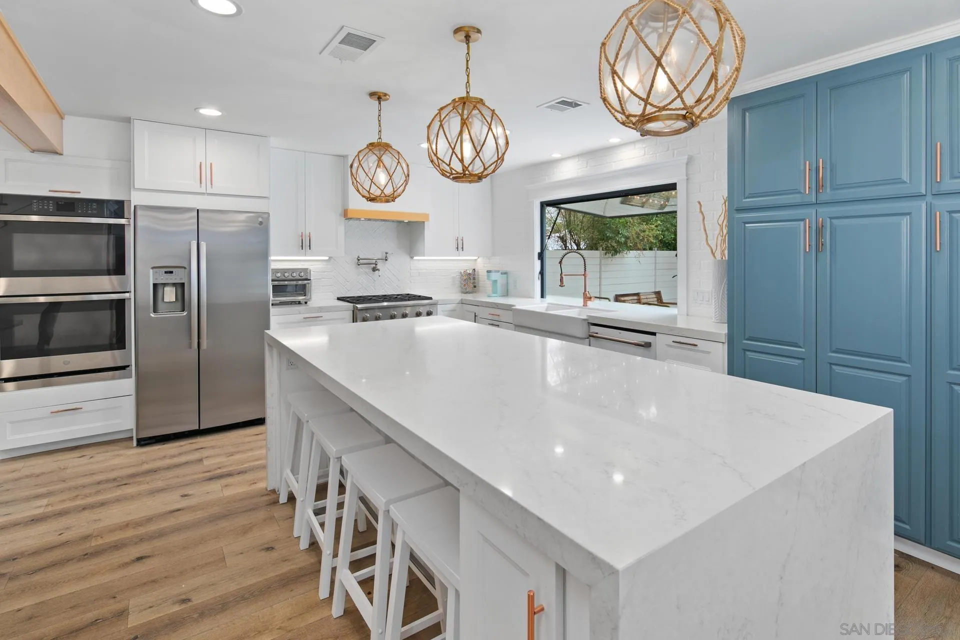 a very nice looking open kitchen with a large window