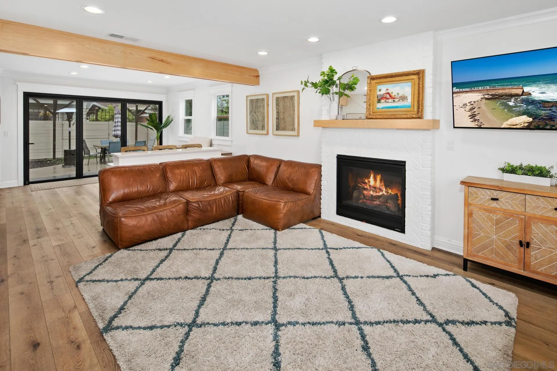 1520 Pendleton Road Coronado, CA 92118 - Photo 11 of 27 a living room with furniture a flat screen tv and a fireplace