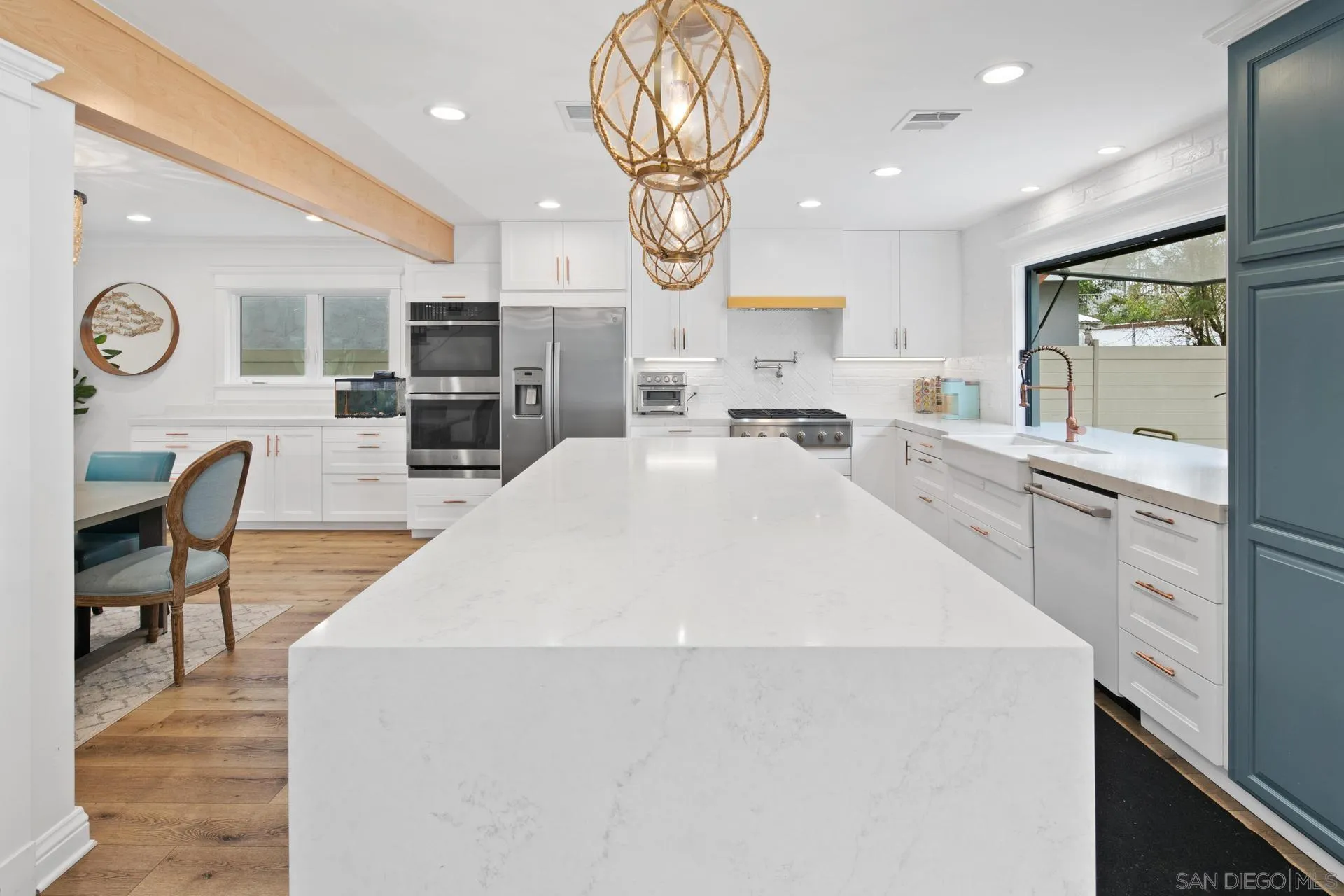 1520 Pendleton Road Coronado, CA 92118 - Photo 4 of 27 a large white kitchen with lots of counter space a sink and appliances
