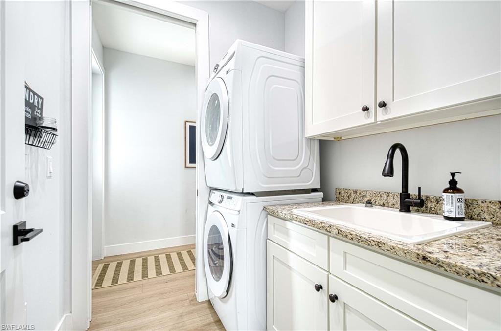 1147 Steeves Avenue Naples, FL 34104 - Photo 13 of 35 a bathroom with a sink and a washing machine