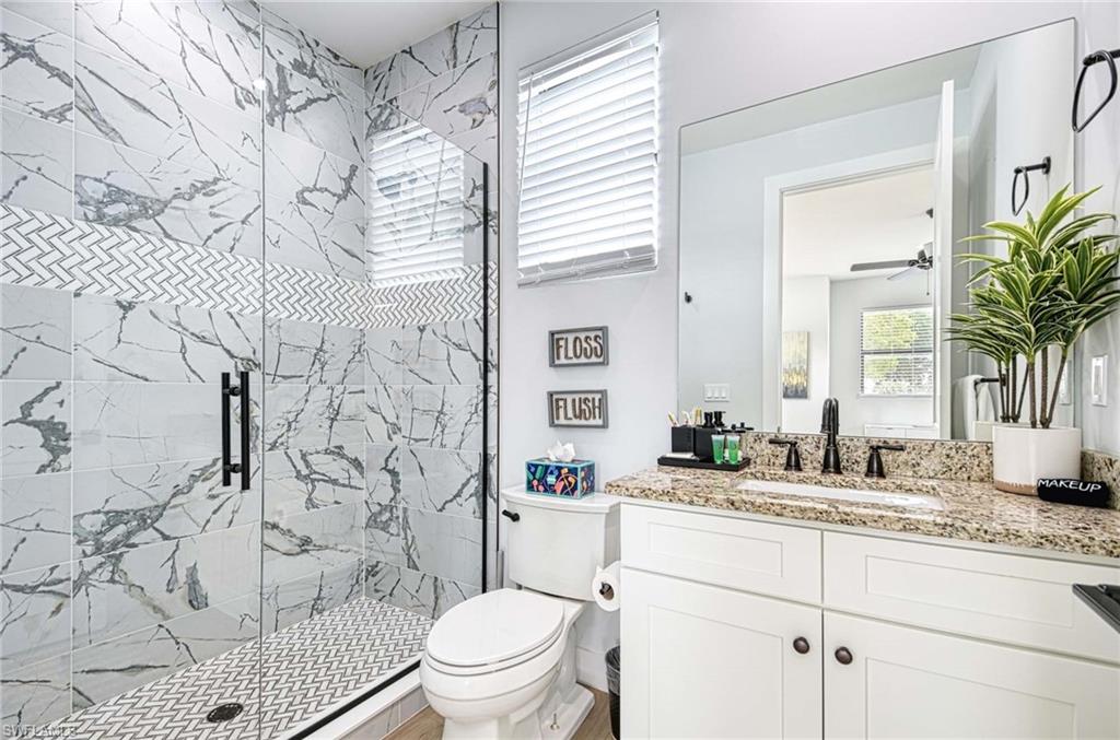 1147 Steeves Avenue Naples, FL 34104 - Photo 19 of 35 a bathroom with a sink toilet and shower