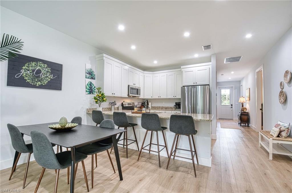 1147 Steeves Avenue Naples, FL 34104 - Photo 23 of 35 a view of a dining room with furniture and wooden floor