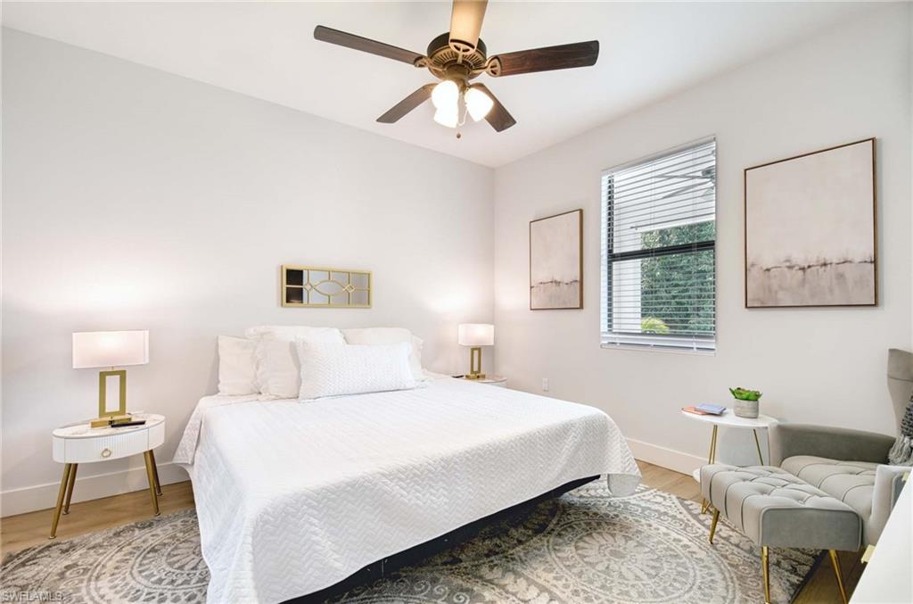 1147 Steeves Avenue Naples, FL 34104 - Photo 31 of 35 a bedroom with a bed and a chandelier