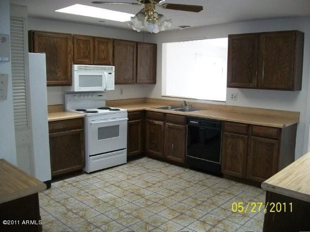 1831 West Decatur Street Mesa, AZ 85201 - Photo 4 of 10 a kitchen with a sink stove and cabinets
