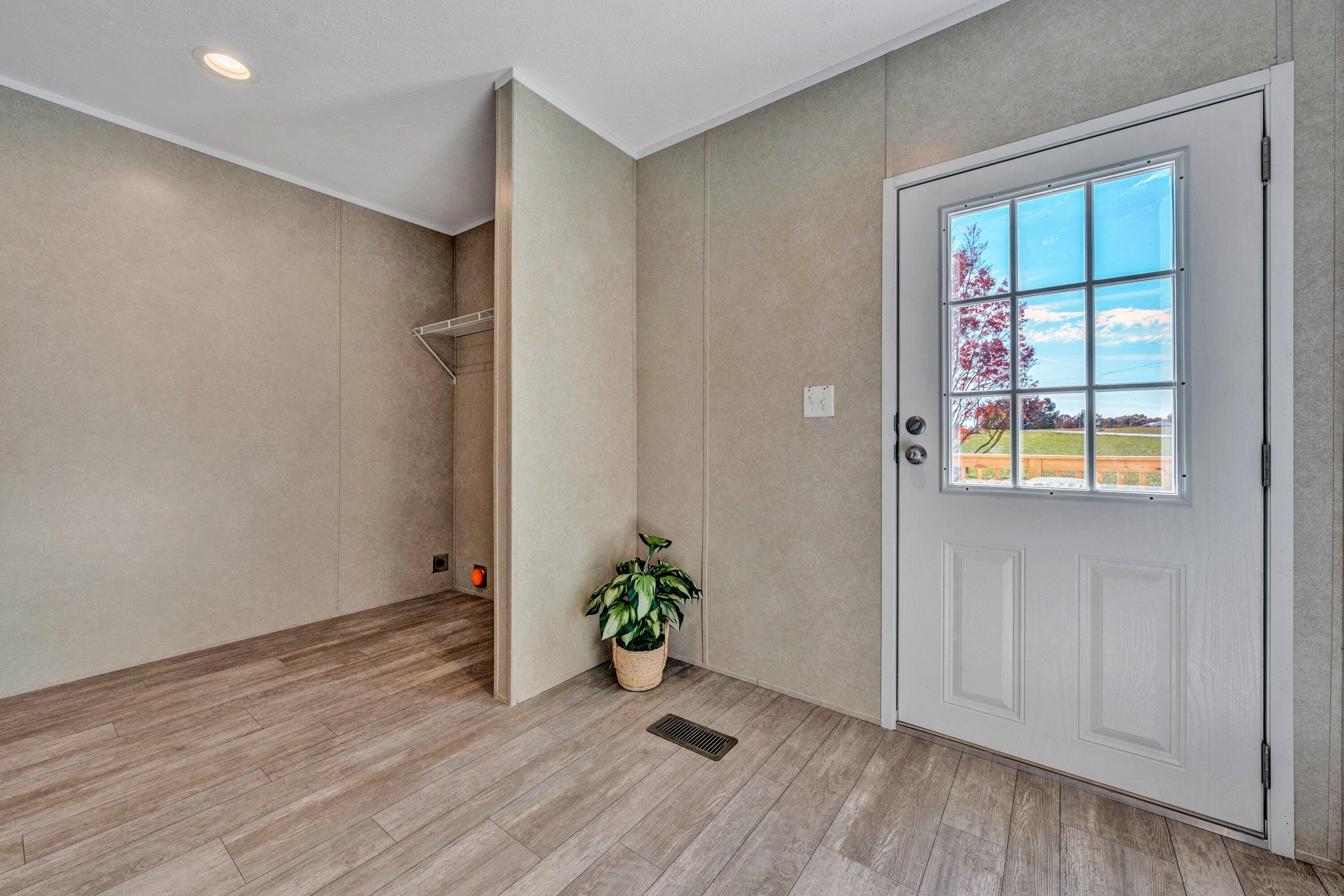 2098 Lipscomb Road Moneta, VA 24121 - Photo 16 of 27 an empty room with wooden floor and a window