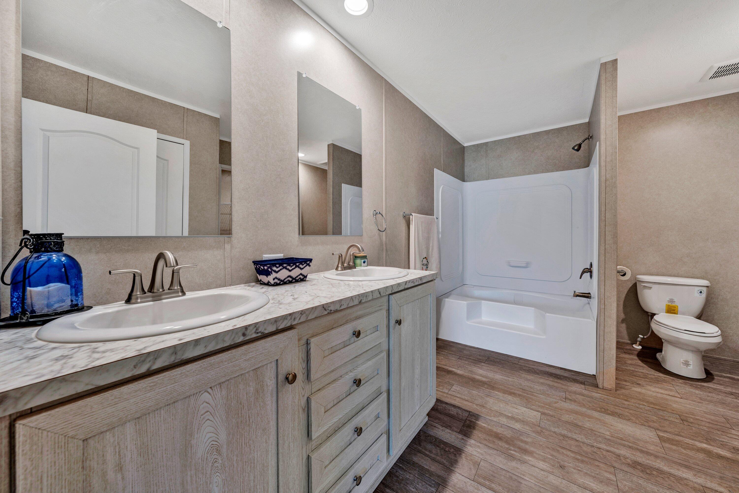 2098 Lipscomb Road Moneta, VA 24121 - Photo 19 of 27 a bathroom with a granite countertop sink mirror and double
