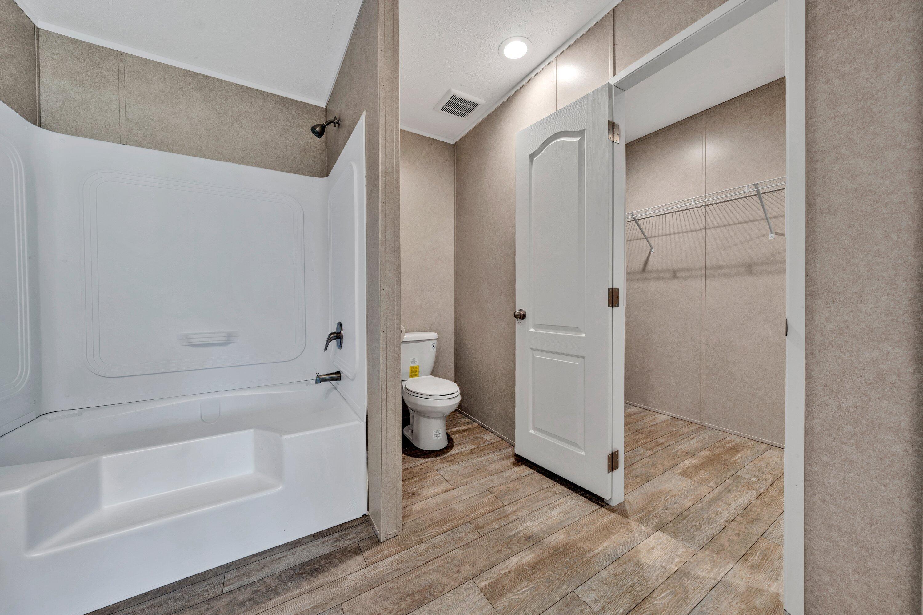 2098 Lipscomb Road Moneta, VA 24121 - Photo 20 of 27 a bathroom with a tub shower and toilet