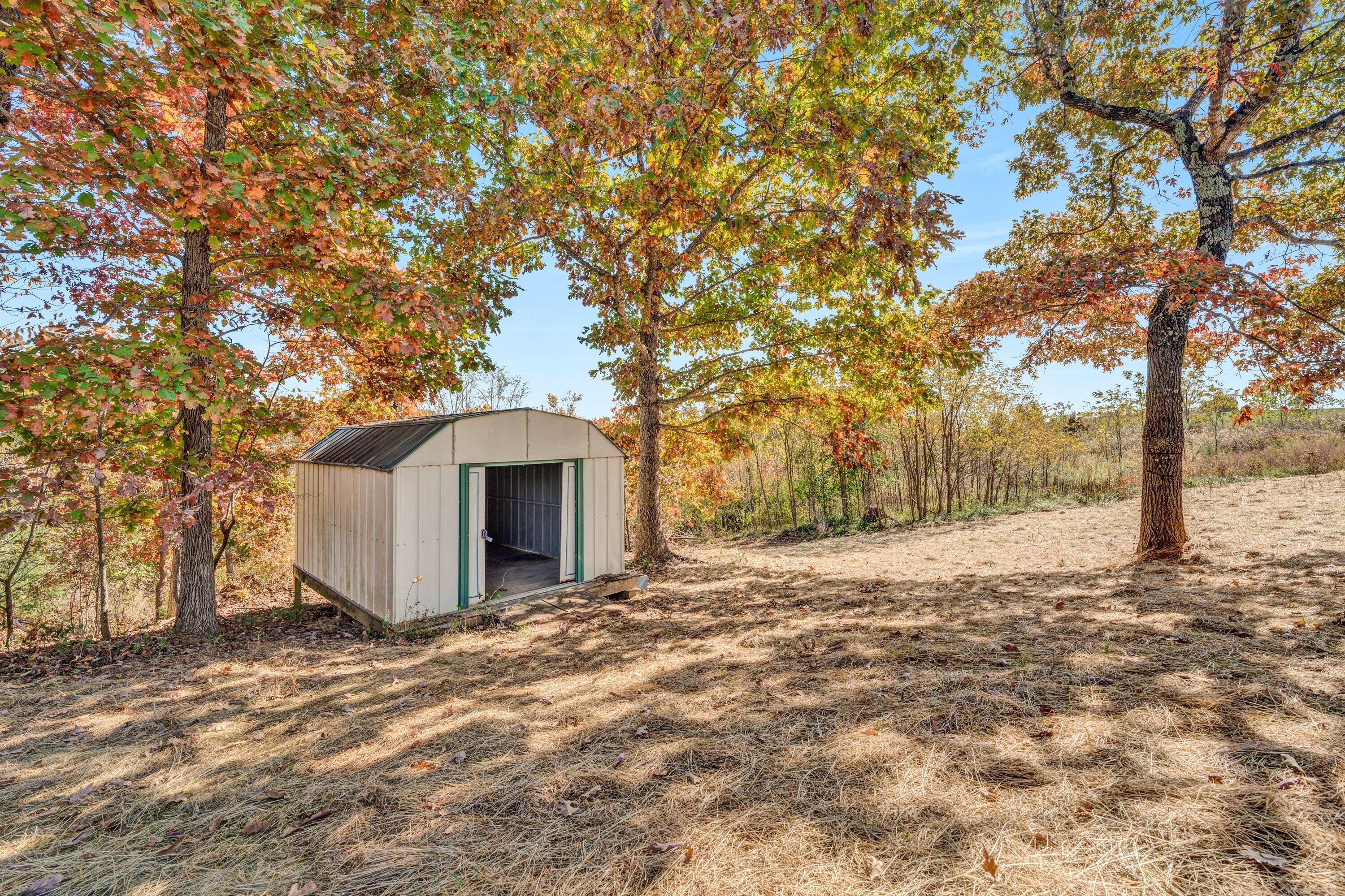 2098 Lipscomb Road Moneta, VA 24121 - Photo 24 of 27 a white house with a large tree in front of it