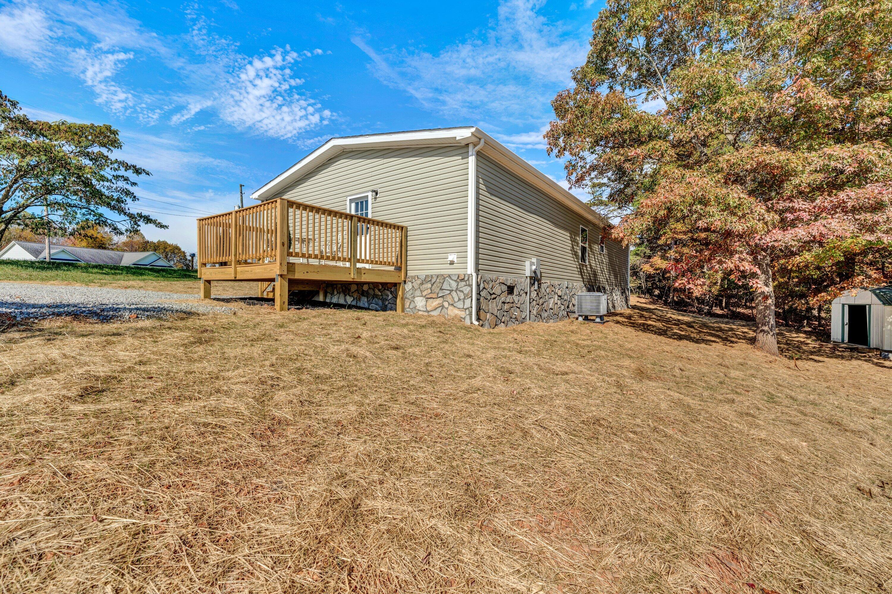 2098 Lipscomb Road Moneta, VA 24121 - Photo 26 of 27 a backyard of a house with large trees