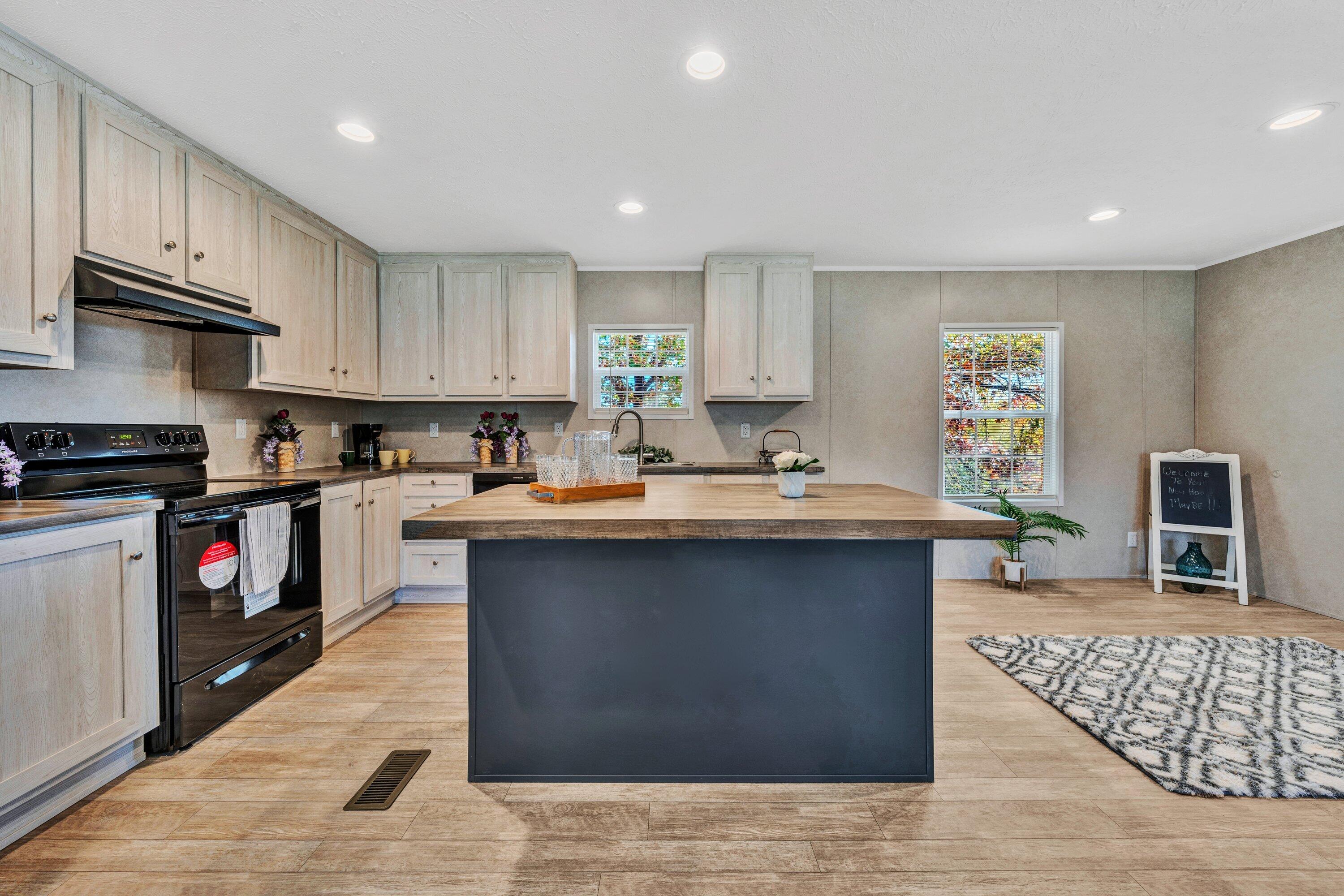 2098 Lipscomb Road Moneta, VA 24121 - Photo 7 of 27 a kitchen with stainless steel appliances granite countertop a stove top oven a sink dishwasher and cabinets with wooden floor