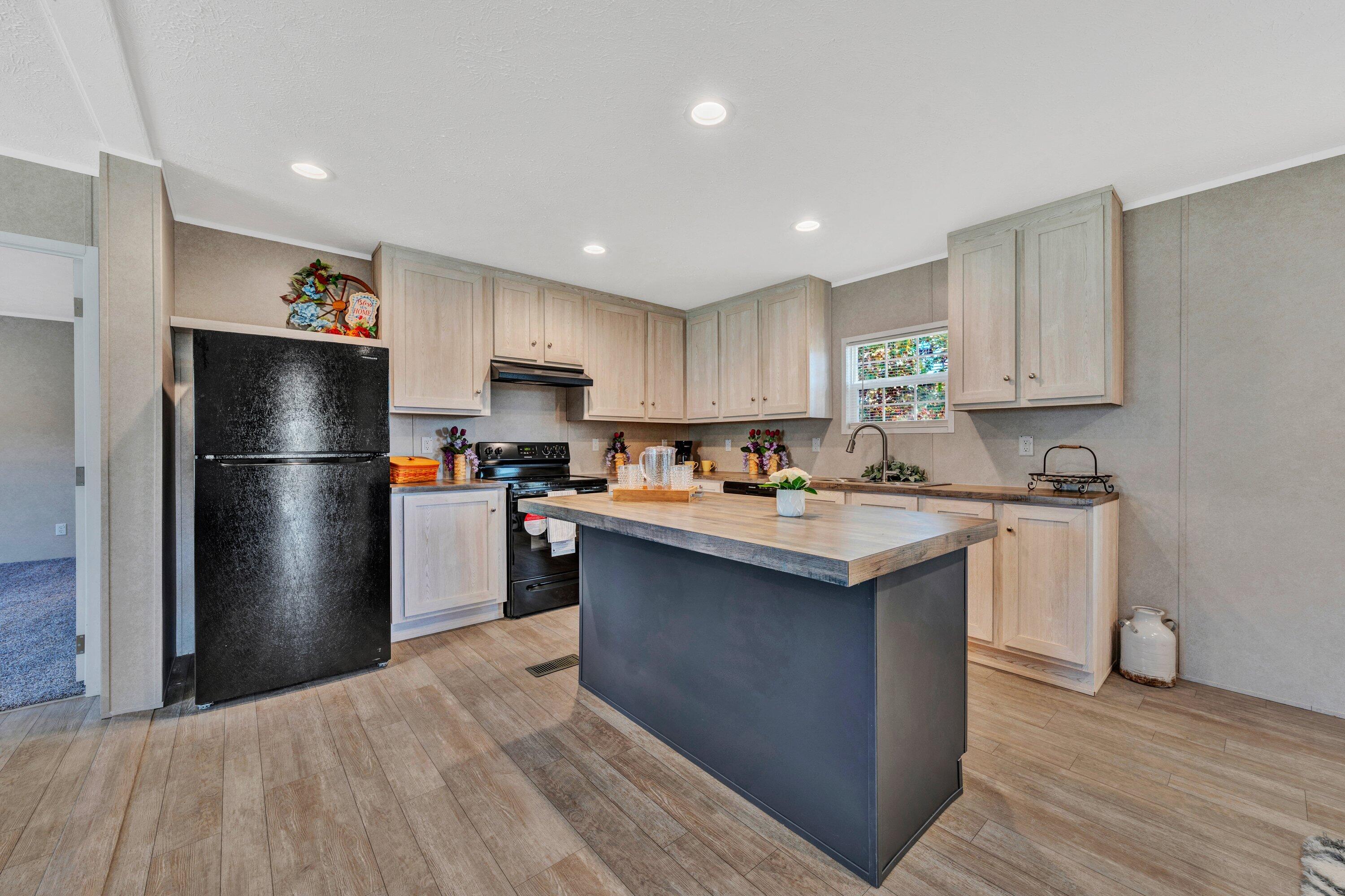 2098 Lipscomb Road Moneta, VA 24121 - Photo 8 of 27 a kitchen with stainless steel appliances granite countertop a refrigerator a sink a stove and a refrigerator