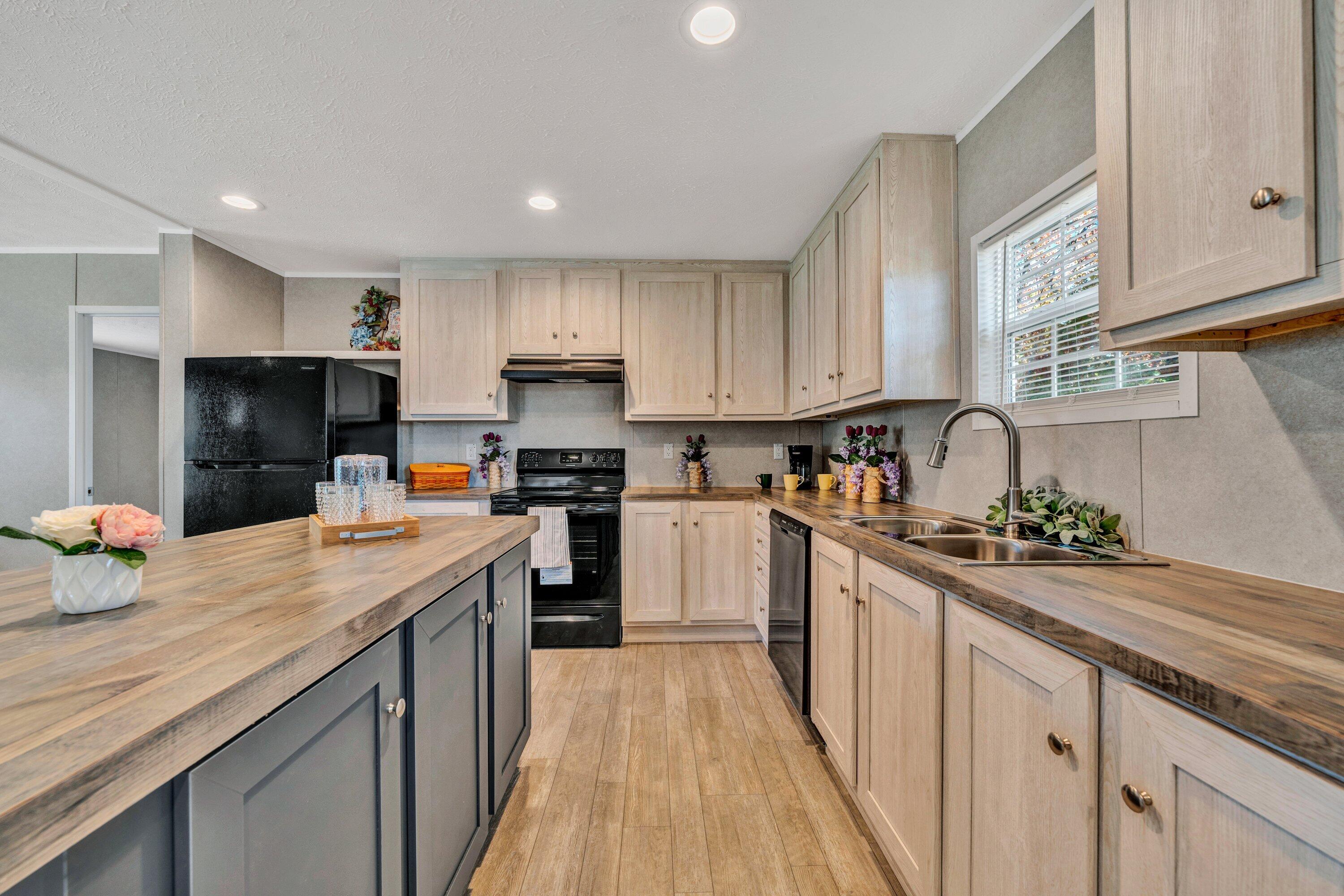 2098 Lipscomb Road Moneta, VA 24121 - Photo 9 of 27 a kitchen with granite countertop a sink stove and cabinets
