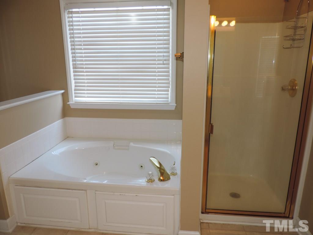 1901 Crag Burn Lane Raleigh, NC 27604 - Photo 11 of 16 a bathroom with a bathtub and a window
