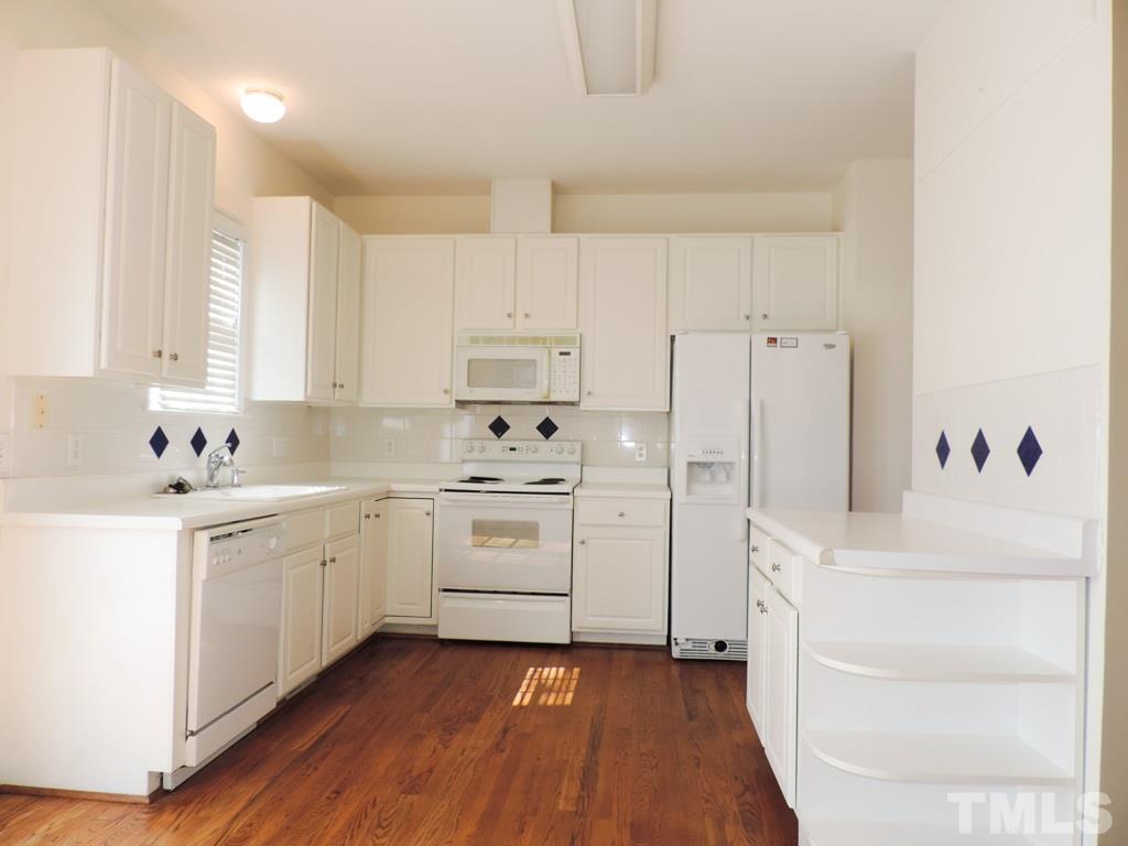 1901 Crag Burn Lane Raleigh, NC 27604 - Photo 3 of 16 a kitchen with white cabinets and white appliances