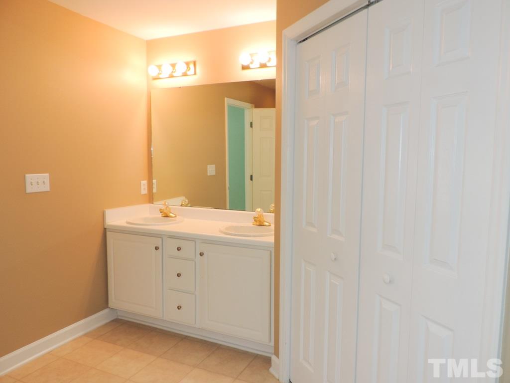 1901 Crag Burn Lane Raleigh, NC 27604 - Photo 10 of 16 a bathroom with a double vanity sink and a mirror