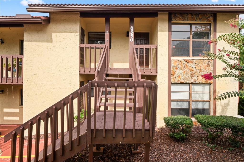 8550 Shadblow Court, Unit 10 Port Richey, FL 34668 - Photo 1 of 1 a view of a brick house with large windows