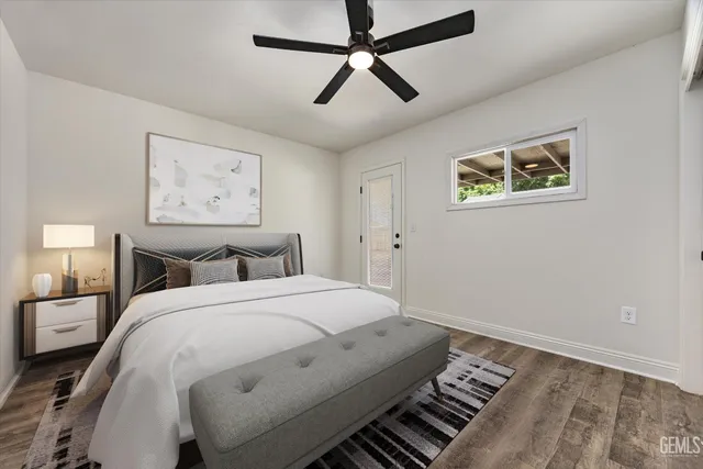 a bedroom with a bed and a painting on the wall