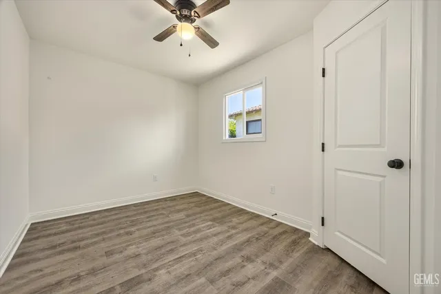 a view of a room with wooden floor and fan