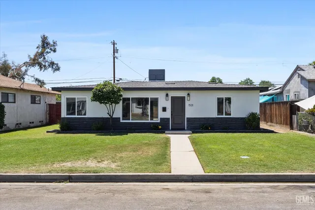 a view of a house with a yard and deck