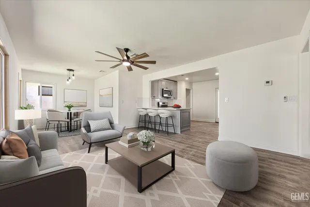 a living room with furniture and a wooden floor