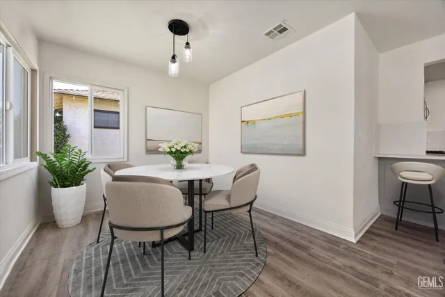 a view of a dining room with furniture and wooden floor