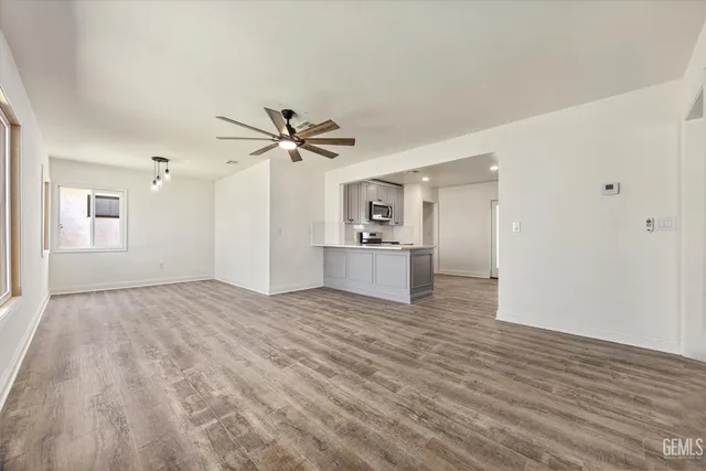 a view of a kitchen with a sink and cabinet with wooden floor