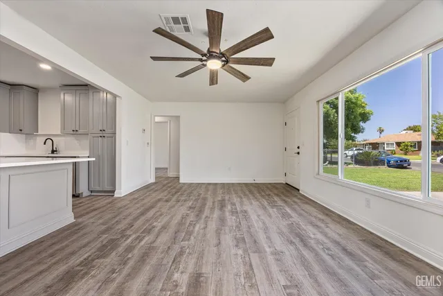 a view of kitchen with sink and wooden floor
