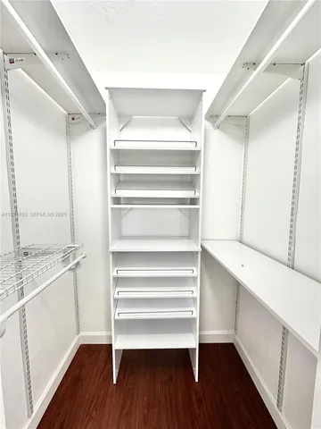 a view of walk in closet with empty racks