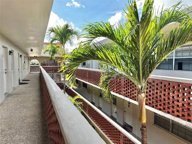 a balcony with chairs and wooden fence