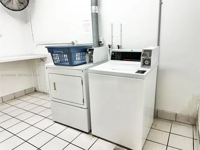 a view of washer and dryer with kitchen in the background