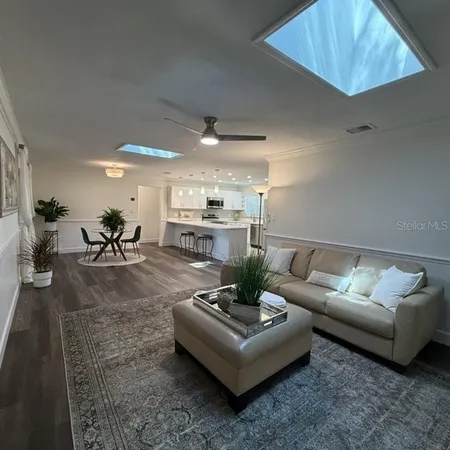 a living room with furniture and a chandelier