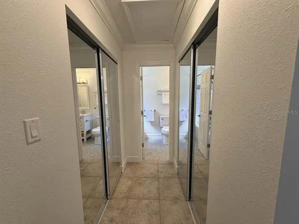 a bathroom with a glass shower door and a bathroom sink