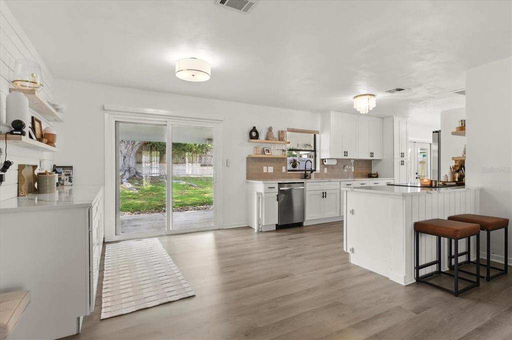 611 Bryan Court Altamonte Springs, FL 32701 - Photo 13 of 37 a kitchen with white cabinets and white appliances