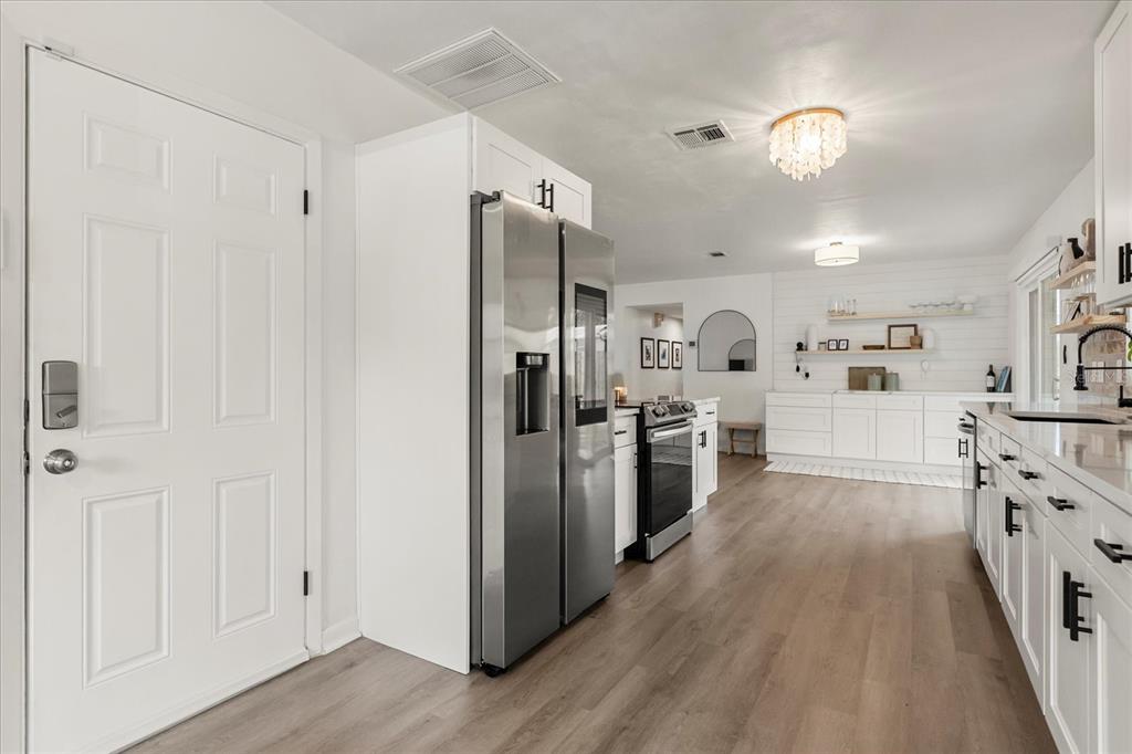 611 Bryan Court Altamonte Springs, FL 32701 - Photo 19 of 37 a kitchen with stainless steel appliances a refrigerator and a cabinets