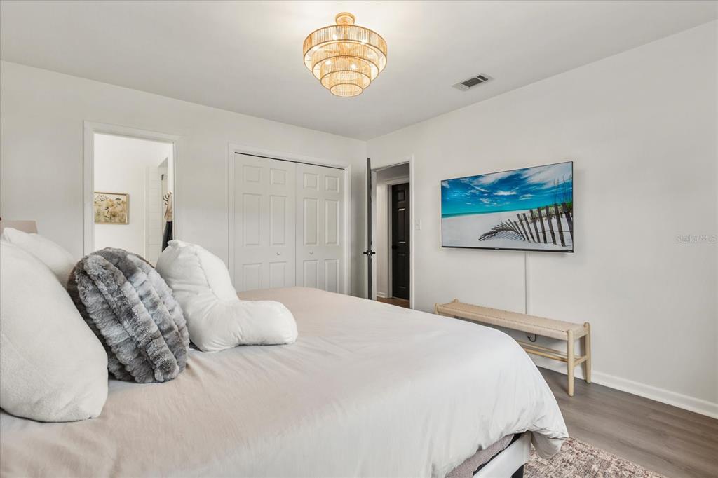 611 Bryan Court Altamonte Springs, FL 32701 - Photo 24 of 37 a bedroom with a bed and a table