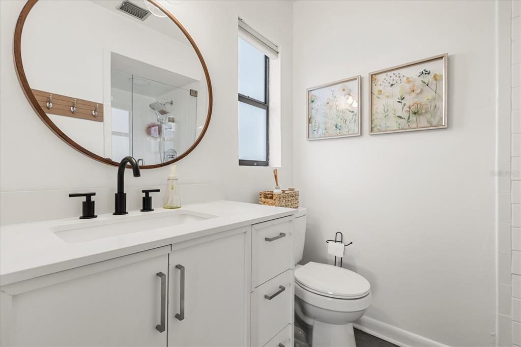 611 Bryan Court Altamonte Springs, FL 32701 - Photo 26 of 37 a bathroom with a toilet a sink and a mirror