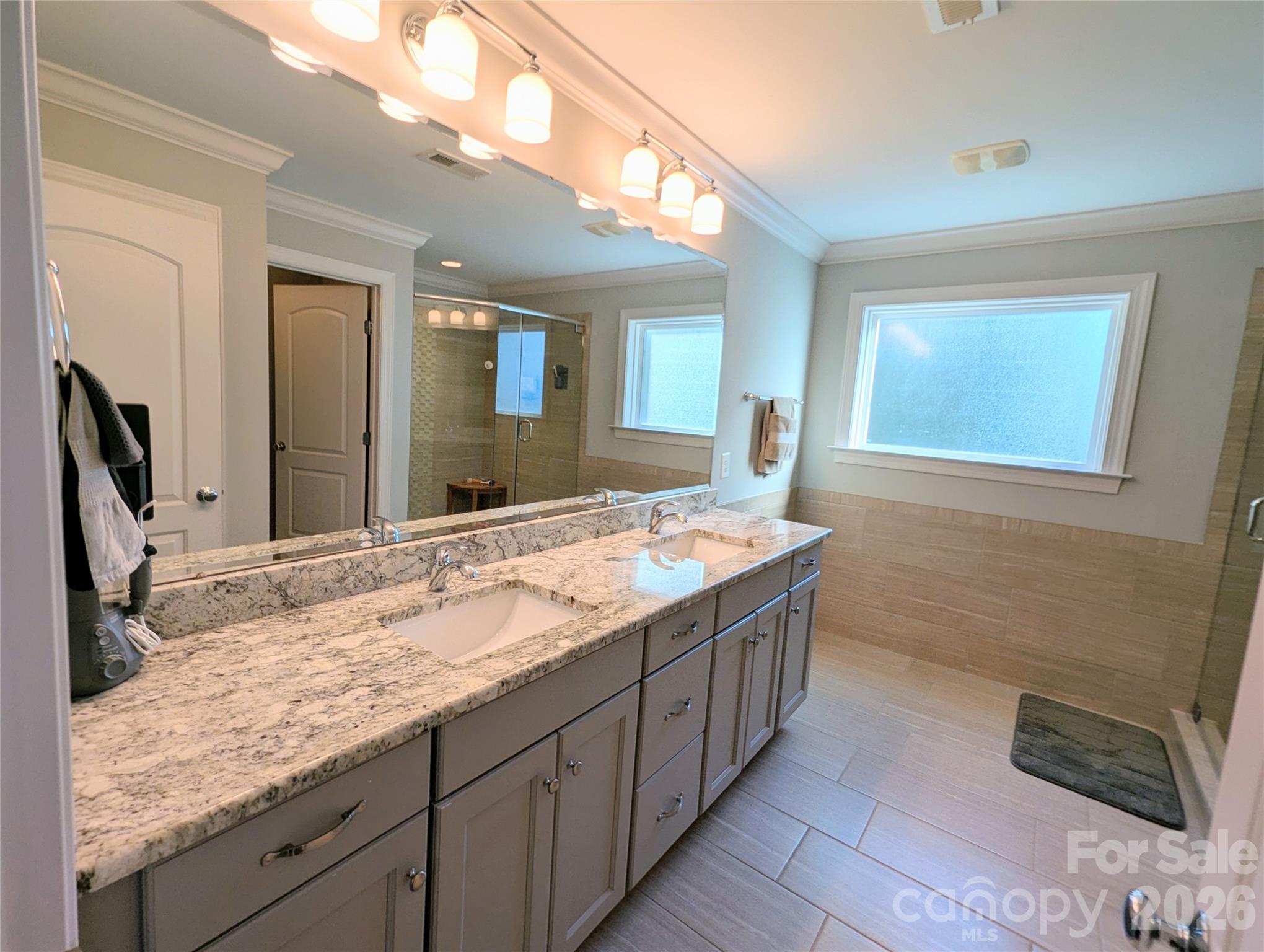 19934 Walter Henderson Road Cornelius, NC 28031 - Photo 31 of 35 a bathroom with a granite countertop double vanity sink and a mirror